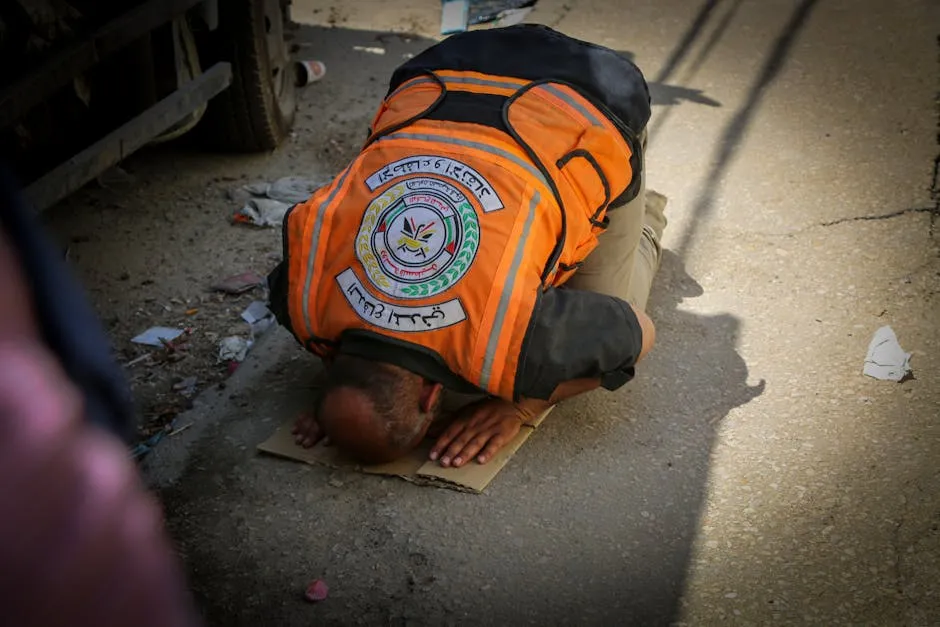 Man Praying on Street for People Under Debris