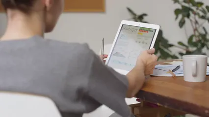 Horizontal video: A woman discussing about charts and data in a smart pad 3252856. Duration: 12 seconds. Resolution: 3840x2160