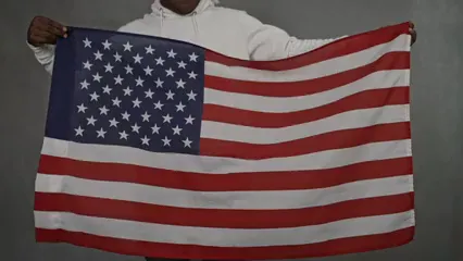 Horizontal video: Person holding a flag 4994040. Duration: 11 seconds. Resolution: 3840x2160