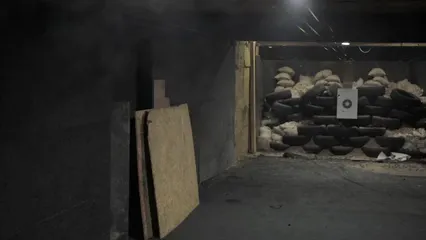 Horizontal video: Man at the indoor shooting range 5243195. Duration: 10 seconds. Resolution: 1920x1080