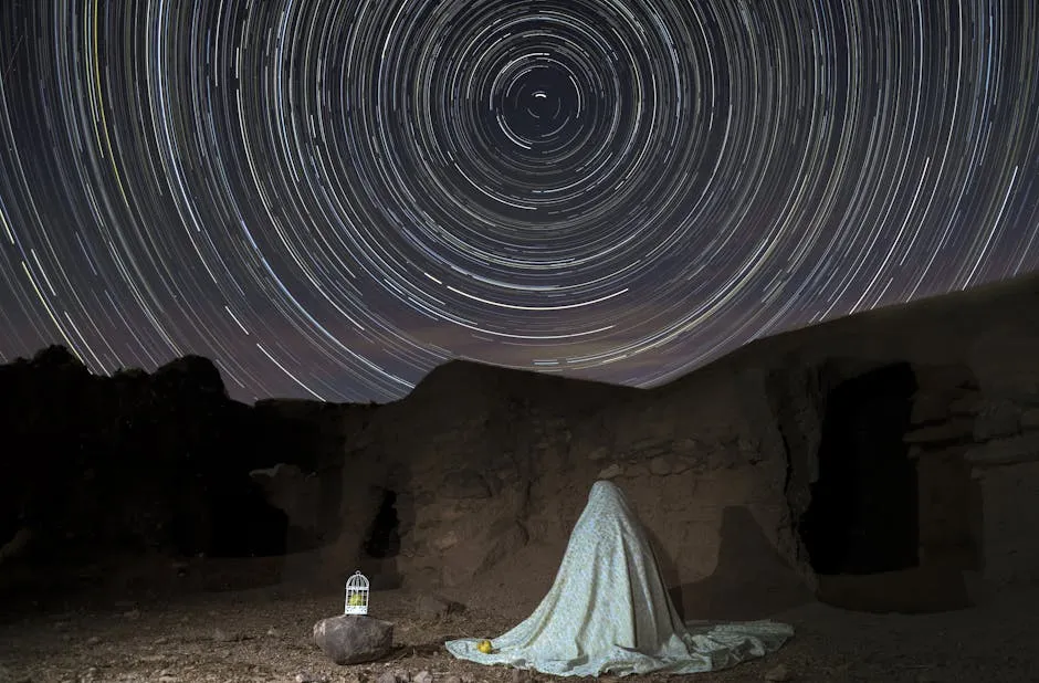 Woman Under White Blanket Sitting and Observing Night Sky