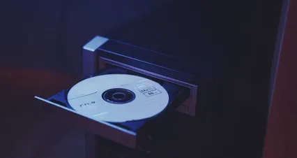Horizontal video: A person removing cd from the disk tray 5473792. Duration: 21 seconds. Resolution: 4096x2160