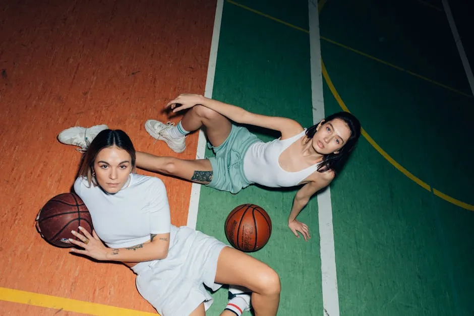 3 Women in White Tank Top and Black Shorts Sitting on Basketball Court