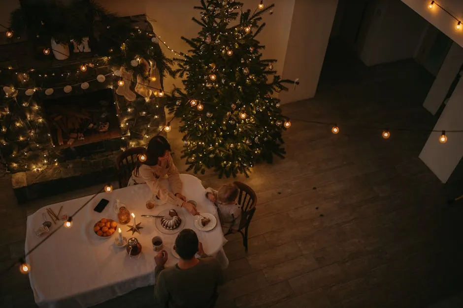 Woman in White Long Sleeve Shirt Sitting on Chair Beside Green Christmas Tree