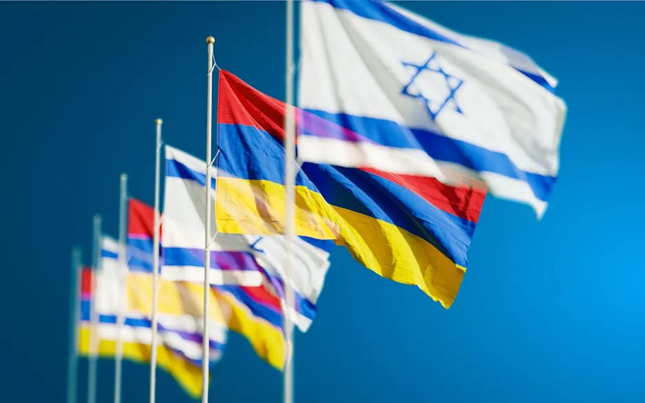 Armenia and Israel Flags against Blue Sky