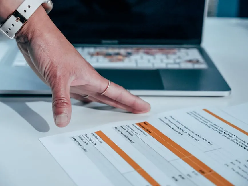White Printed Paper with Texts Near the Laptop on the Table