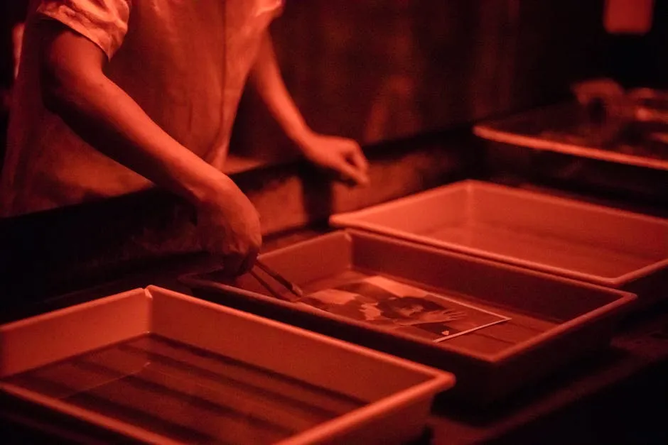 Person Developing a Photograph in the Darkroom 