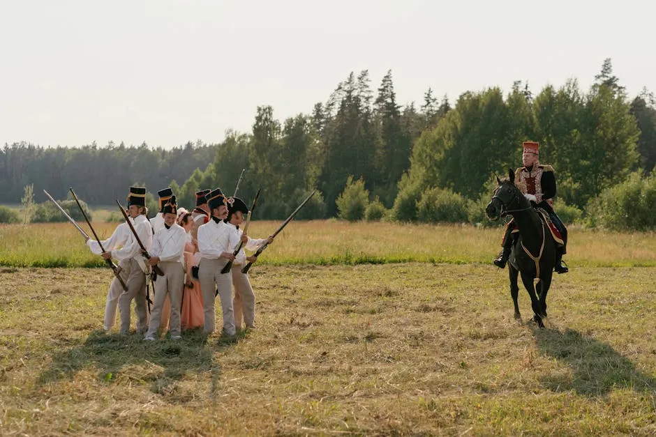 A group of soldiers in historical uniforms participating in a reenactment, featuring a horseback rider.