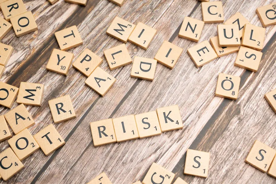 Scrabble tiles spelling out 'risk' scattered on a rustic wooden background, symbolizing uncertainty.