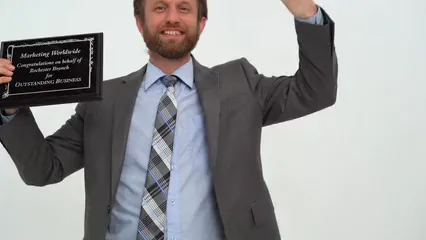 Horizontal video: A man bowing while holding a plaque 7005842. Duration: 11 seconds. Resolution: 3840x2160