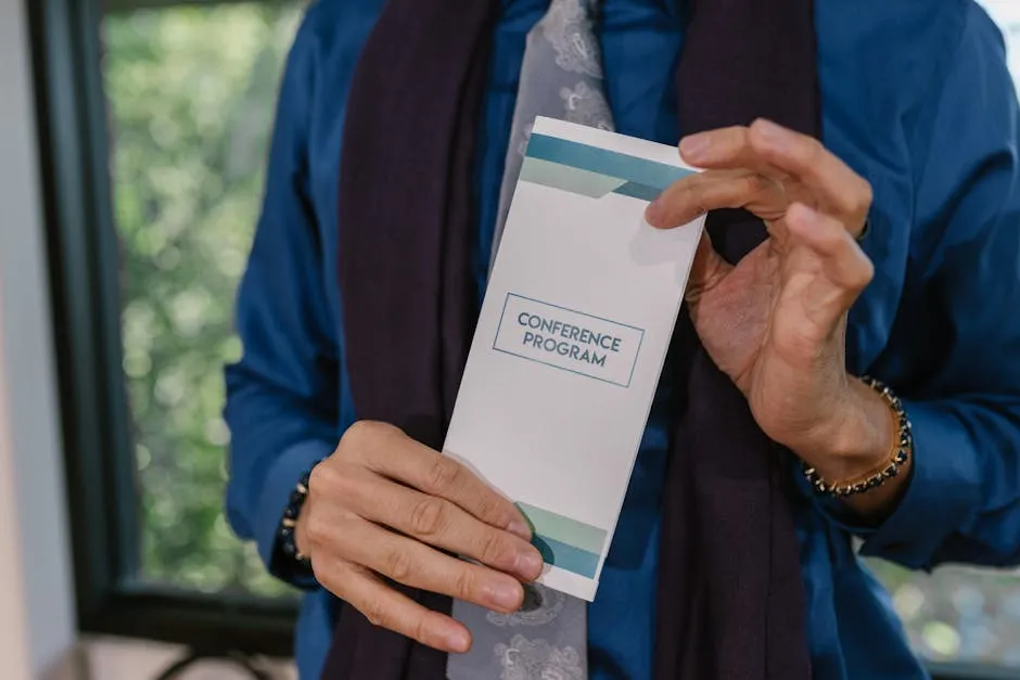 A Person Holding a Program Pamphlet