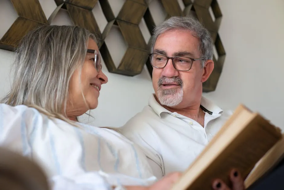 Senior couple enjoying a peaceful moment reading together indoors. Warm and loving atmosphere.