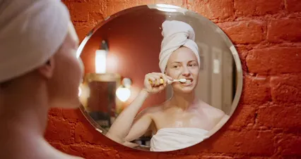 Horizontal video: A woman brushing her teeth n front of the mirror 5137575. Duration: 19 seconds. Resolution: 4096x2160
