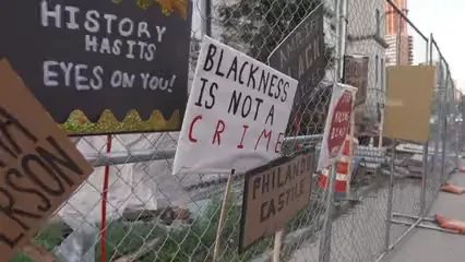 Horizontal video: Placards on wire mesh at empty place after a protest 5286288. Duration: 7 seconds. Resolution: 1920x1080