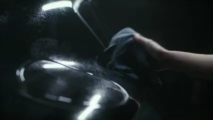 Horizontal video: Person cleaning a black car 6873161. Duration: 23 seconds. Resolution: 3840x2160