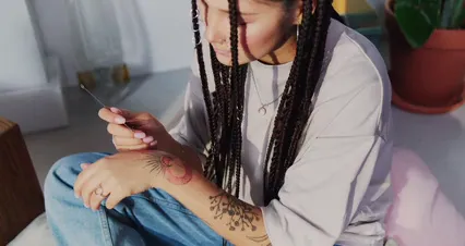 Horizontal video: Woman tattooing herself 7189991. Duration: 44 seconds. Resolution: 4096x2160