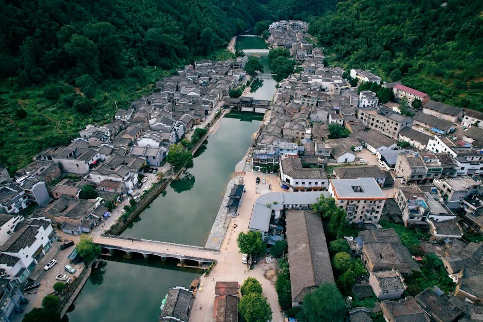 Drone Shot of a Village in a Mountain Valley with a River Running in the Middle 