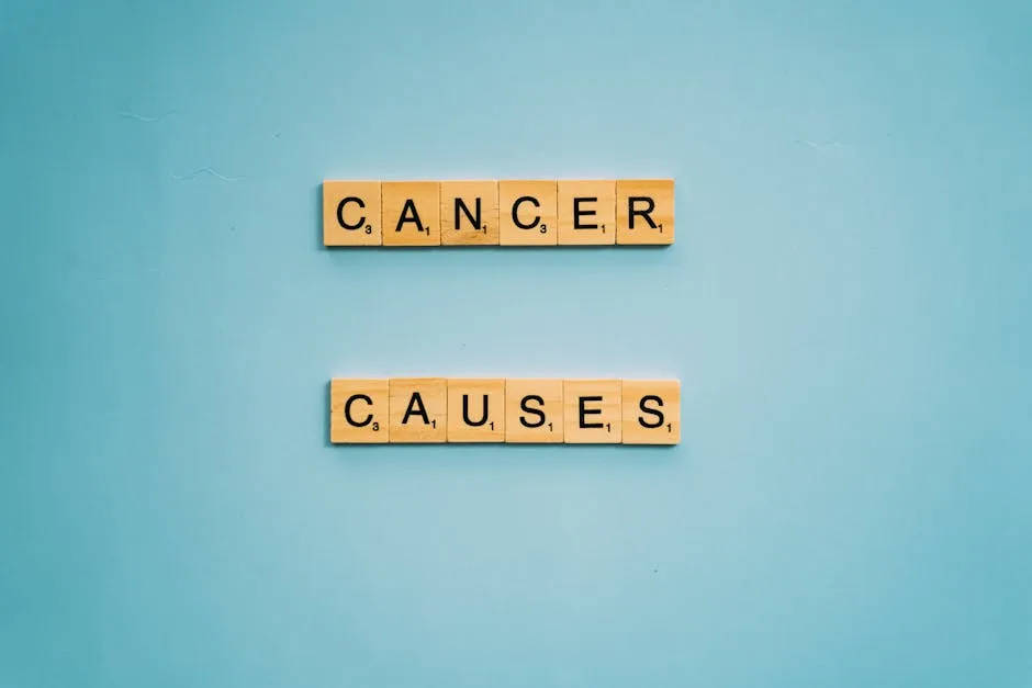 Scrabble tiles spelling 'Cancer Causes' on a light blue background, highlighting awareness.