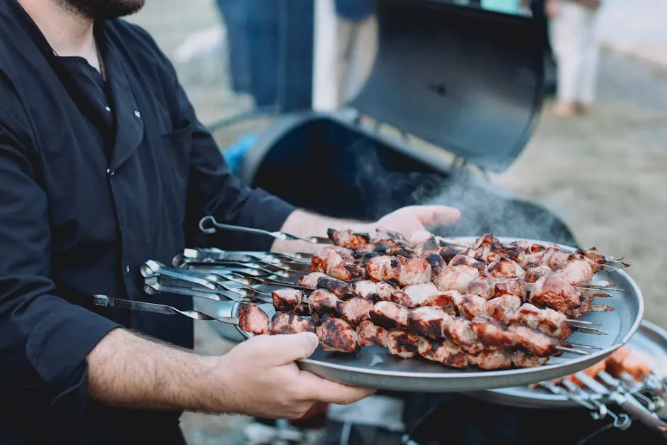 Close-up of a Man Holding a Tray with Grilled Meat 