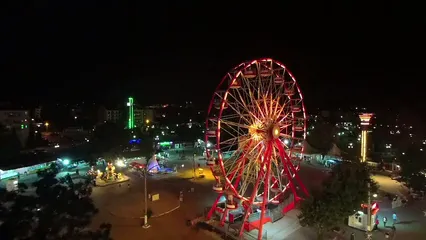 Horizontal video: A red ferris wheel on a fairground 3116906. Duration: 37 seconds. Resolution: 1920x1080