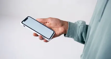 Horizontal video: A person holding a smartphone with blank screen 8165878. Duration: 26 seconds. Resolution: 4096x2160