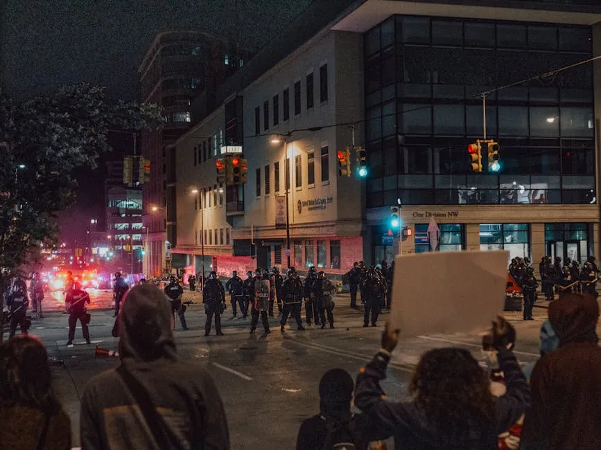 Demonstrators with Protest Signs Facing Police Officers 