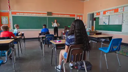 Horizontal video: A young student raising her hand and walking to the front of the class 8499667. Duration: 18 seconds. Resolution: 1920x1080