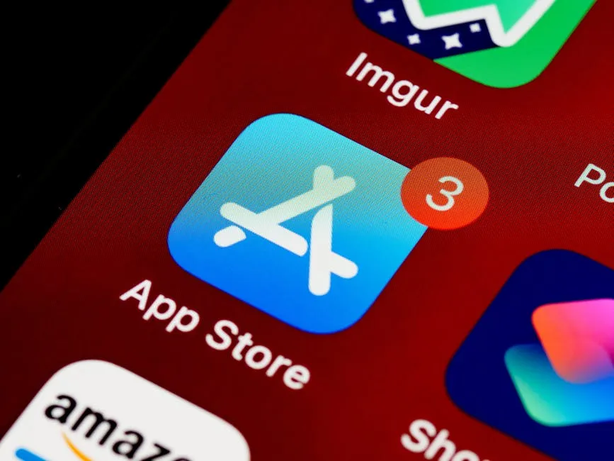 Close-up of App Store icon on iPhone screen with notification badge, highlighting app updates.