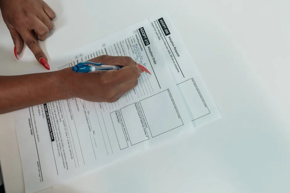 Person Writing on the Documents