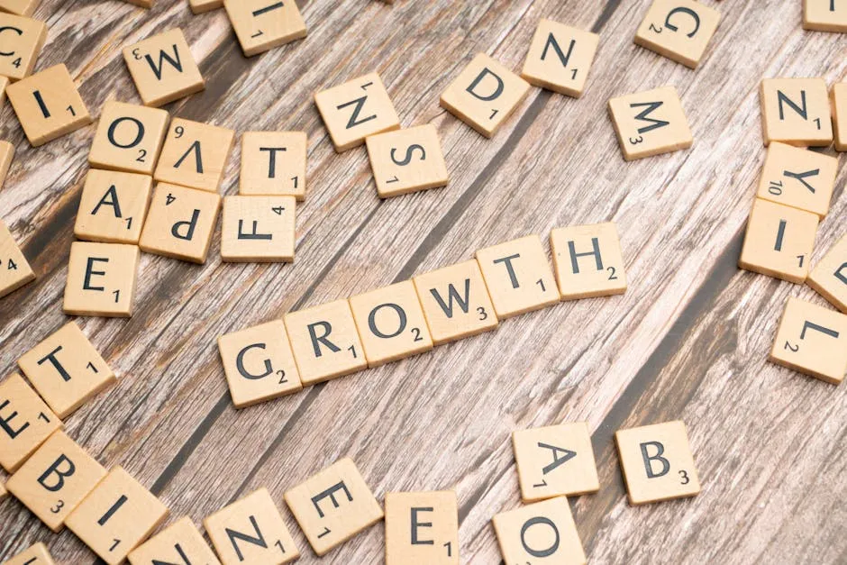 Scrabble tiles spelling 'growth' on a wooden surface symbolize progress and expansion.