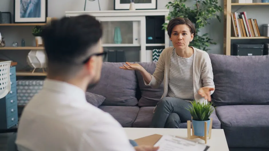 A woman and man sitting on a couch talking