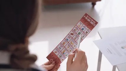 Horizontal video: A person holding a pamphlet of diabetic snack ideas 7579981. Duration: 26 seconds. Resolution: 1920x1080