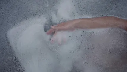 Horizontal video: A person playing with soap suds while bathing in a bathtub 3779921. Duration: 19 seconds. Resolution: 1920x1080